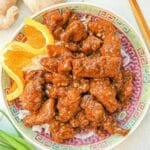 Orange Chicken on a plate with rice.