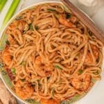 Garlic Shrimp noodles in a bowl with scallions, ginger, and garlic.