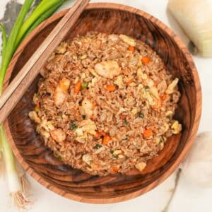 Copycat Benihana Fried Rice in a wooden bowl with chopsticks.