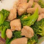 Chicken and Broccoli on a plate with rice.