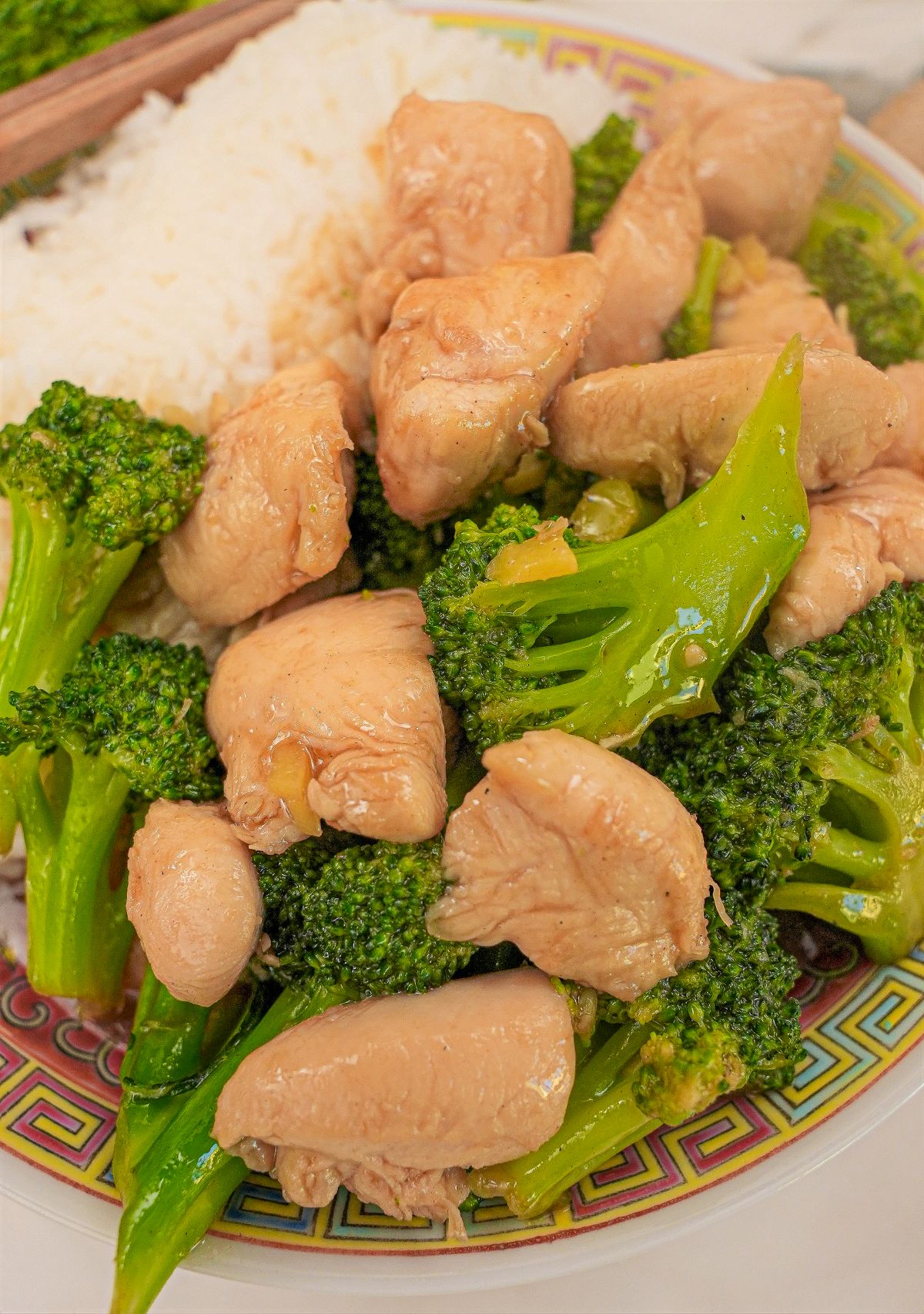 Chicken and Broccoli on a plate with rice.