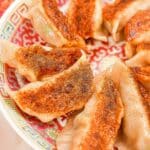 Authentic Chinese Pork Dumplings pan fried on a plate.