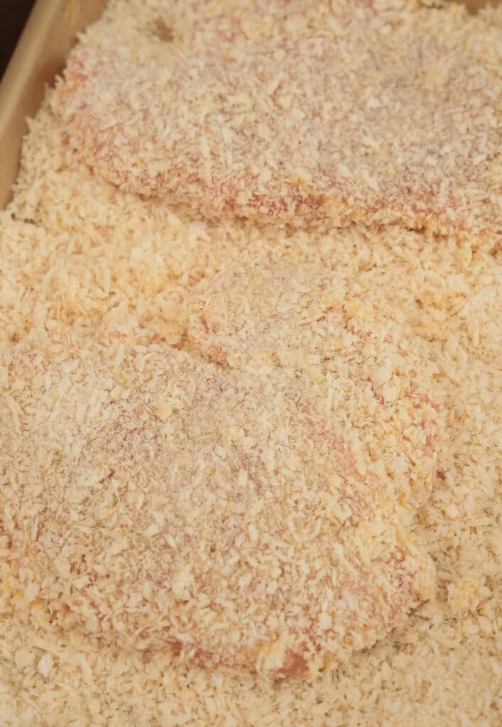breaded chicken in panko breadcrumbs on a tray
