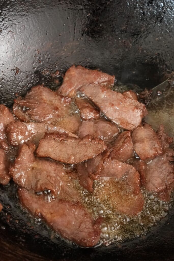 Frying beef in oil for Beef and Broccoli noodles
