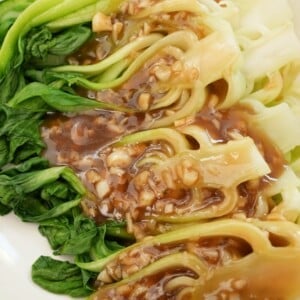 Close up of bok choy with garlic sauce on a plate