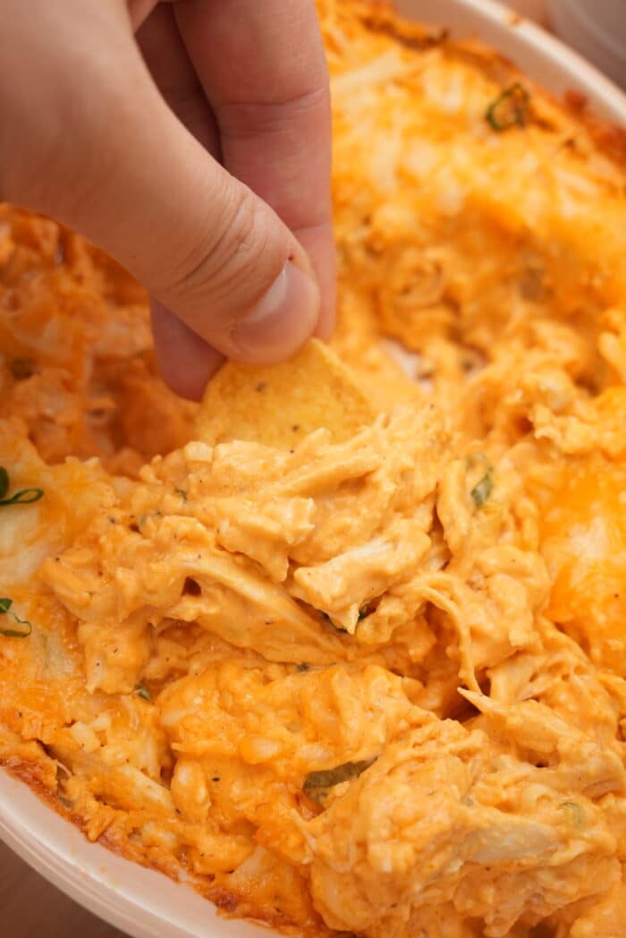 Scooping Buffalo Chicken Dip with chips