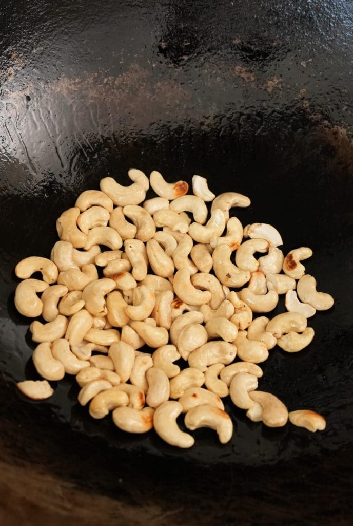 Toasting cashew nuts in a pan