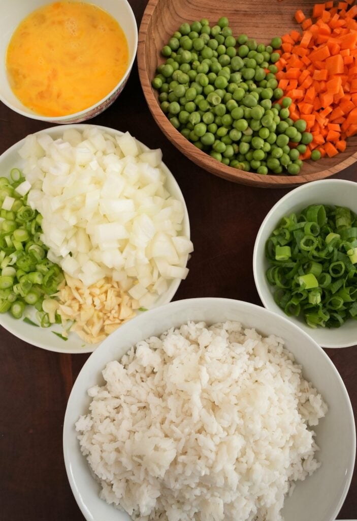 Raw vegetables, eggs, and rice in bowls
