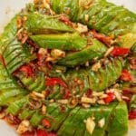 A chinese spirlal chili garlic cucumber salad in a bowl with the chili garlic soy dressing.
