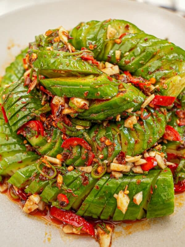A chinese spirlal chili garlic cucumber salad in a bowl with the chili garlic soy dressing.