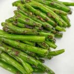 Dry Fried Garlic Green Beans on a white plate.