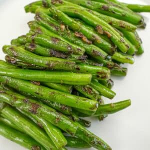Dry Fried Garlic Green Beans on a white plate.