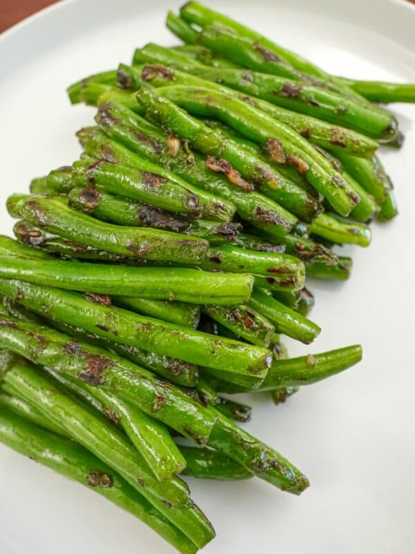 Dry Fried Garlic Green Beans on a white plate.