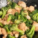 Chicken and Broccoli cooked in a wok.