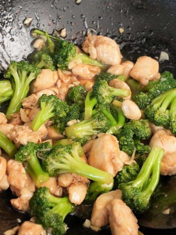 Chicken and Broccoli cooked in a wok.