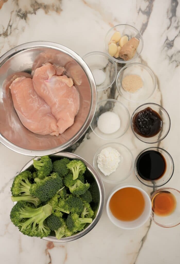 Raw ingredients for Chinese Chicken and Broccoli in bowls.