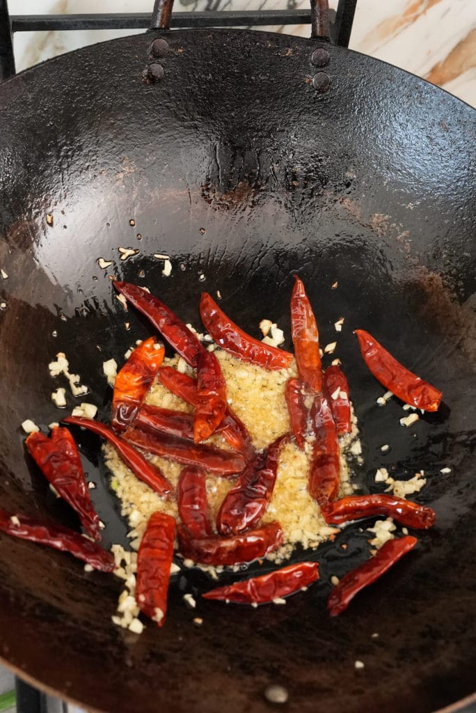 Garlic and chilis cooking in a pan