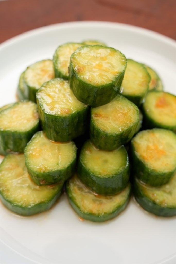 Sliced cucumber salad stacked on a plate