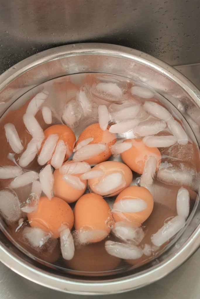 Boiled eggs in a bowl of ice water.