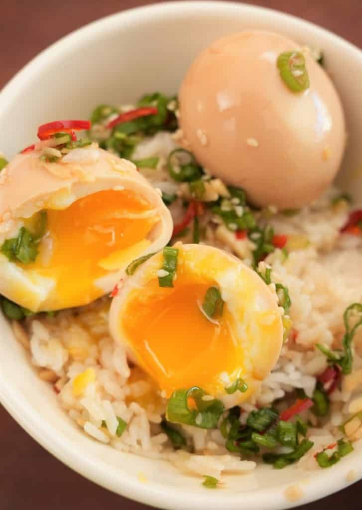 Korean Marinated eggs over rice in a bowl.