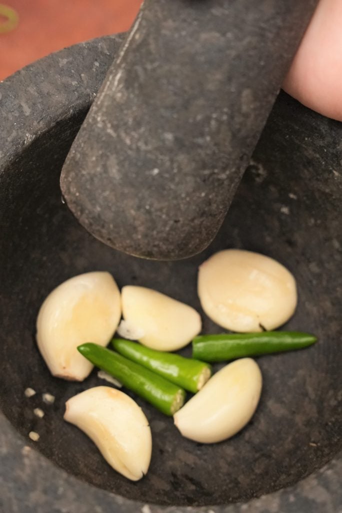 Thai chilis and garlic in a mortar and pestle for Thai Fried Rice.