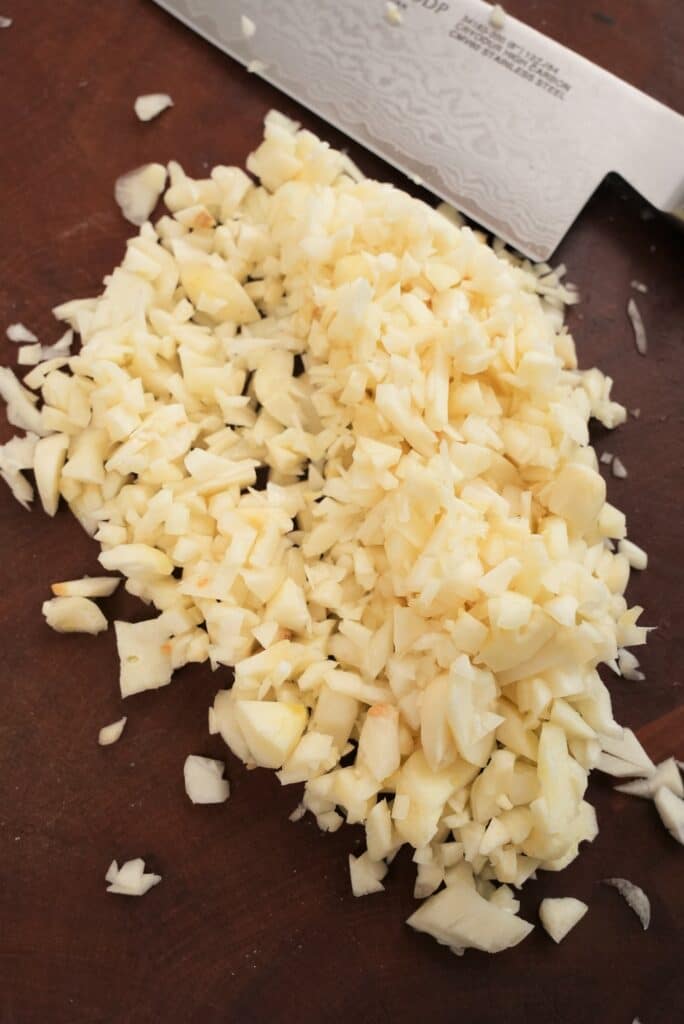 Chopped Garlic on a cutting board.