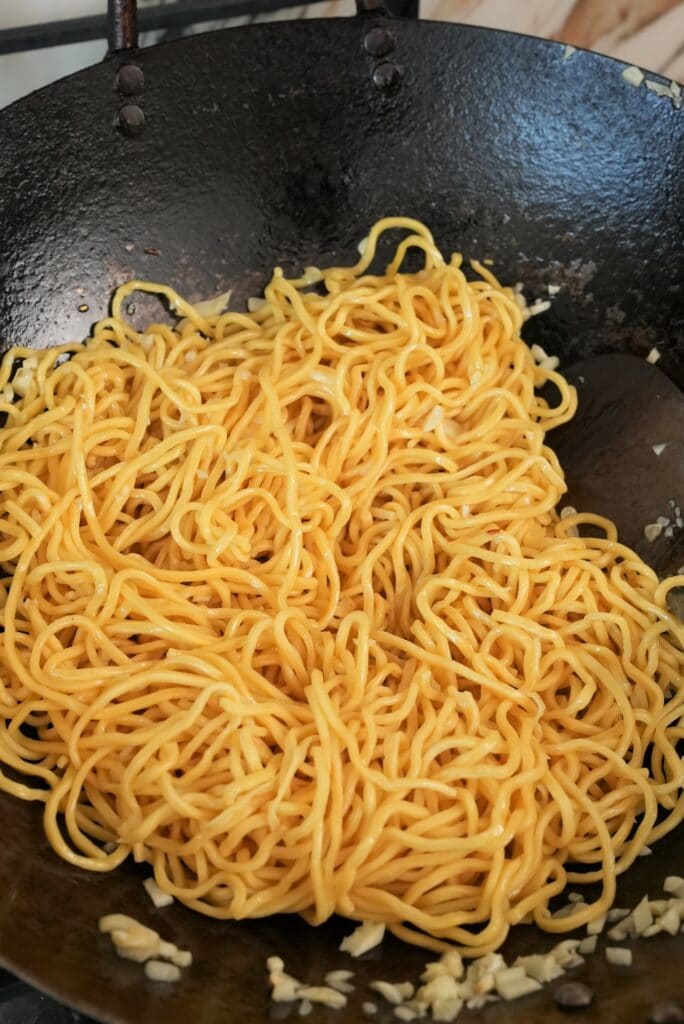 Noodles in a pan with butter and garlic.