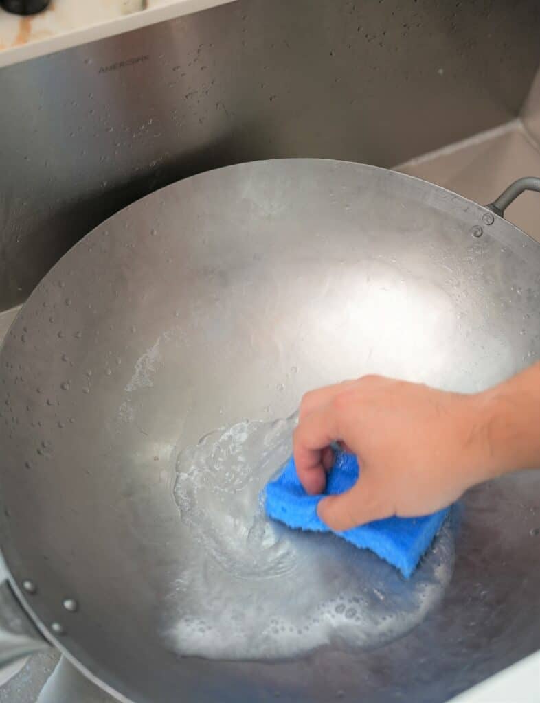 Washing a wok with soap and water