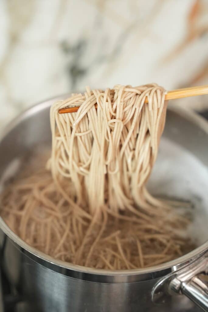 Cooking soba noodles in boiling water.