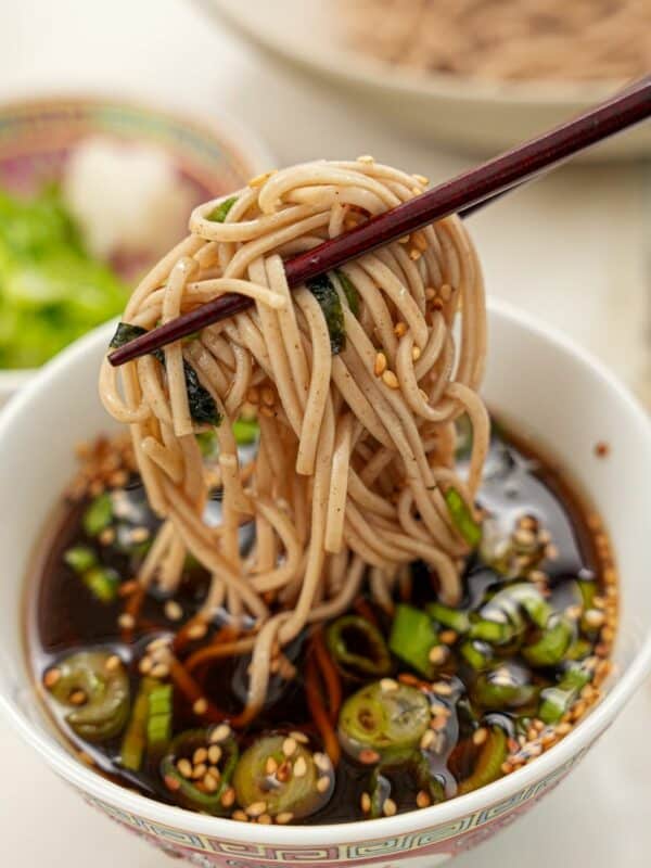 Cold Soba Noodles (Zaru soba) dipping in the sauce with chopsticks.