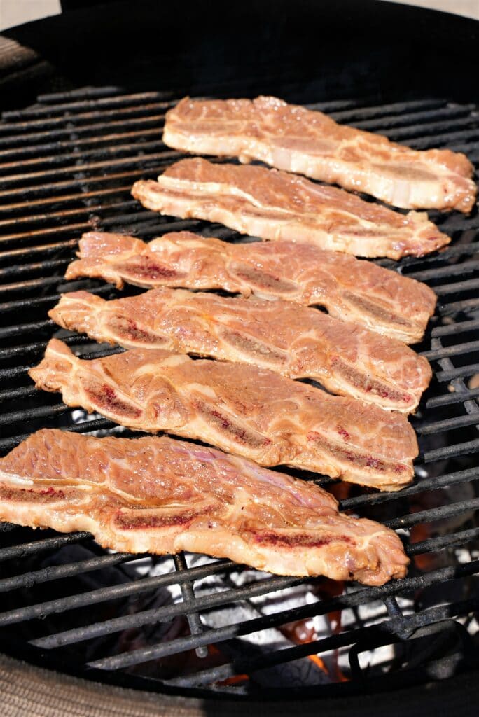 Uncooked Ribs cooking on a grill