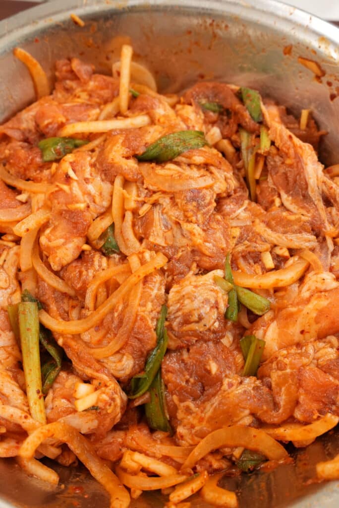 Marinating pork belly in a bowl.