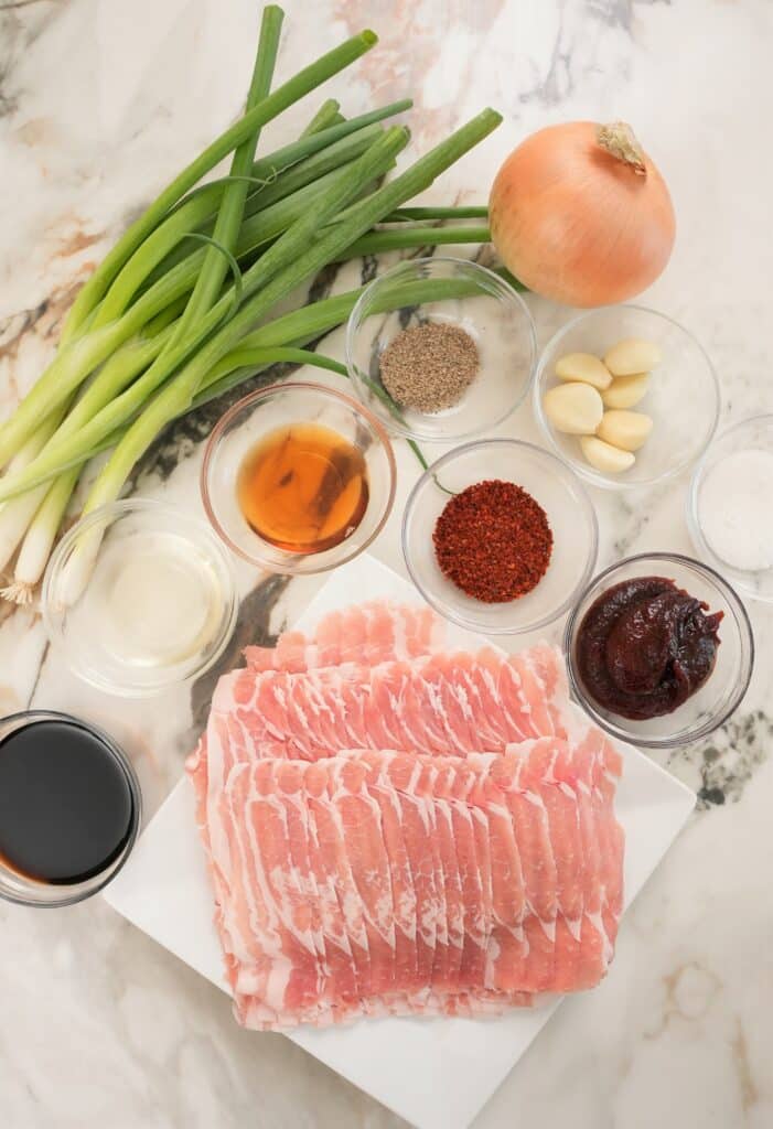 Raw Pork belly and ingredients laid out on a table