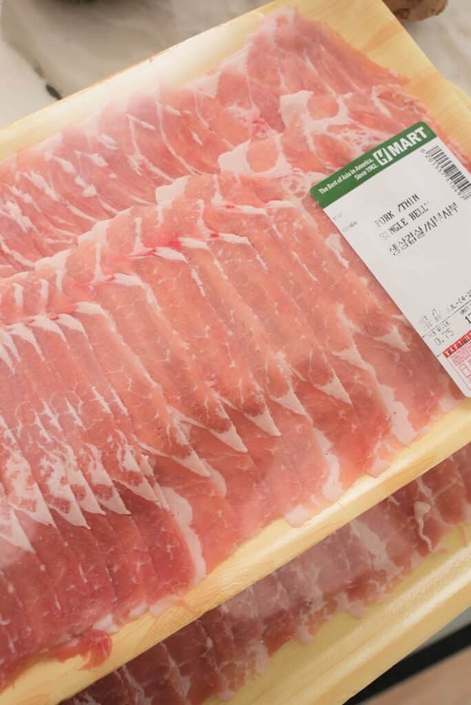 Thinly sliced pork belly in packaging.