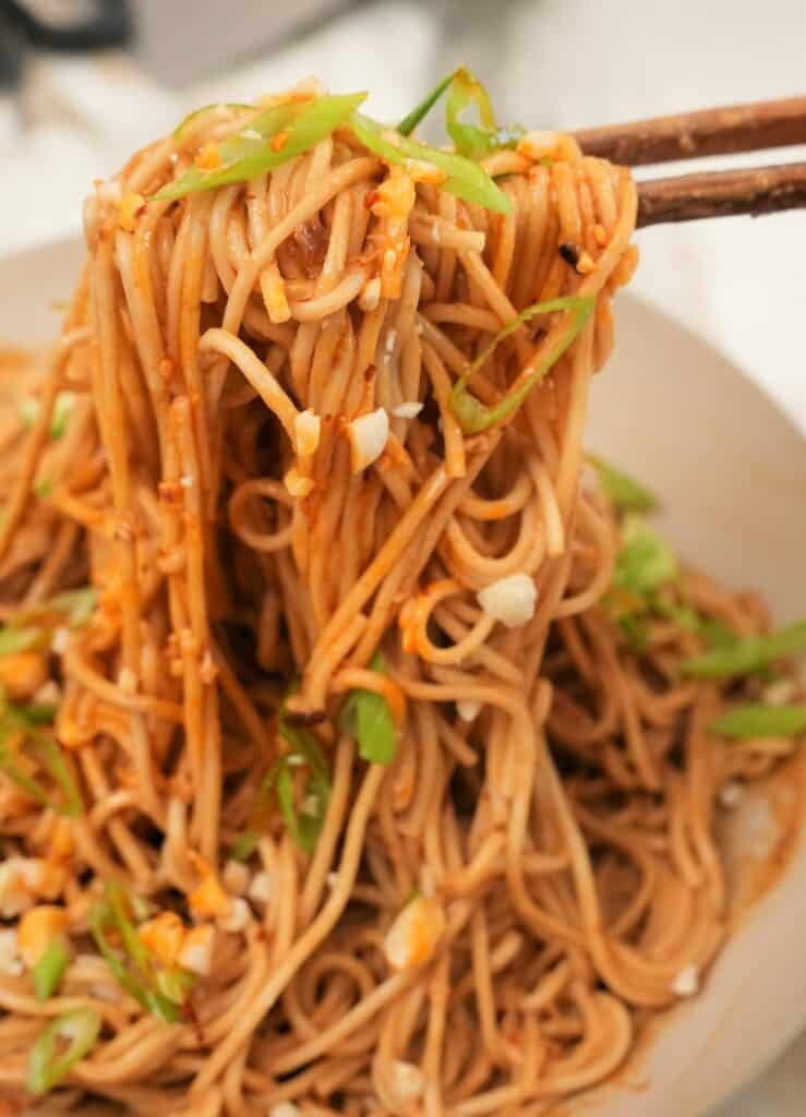 Cold sesame noodles pulled with chopsticks.