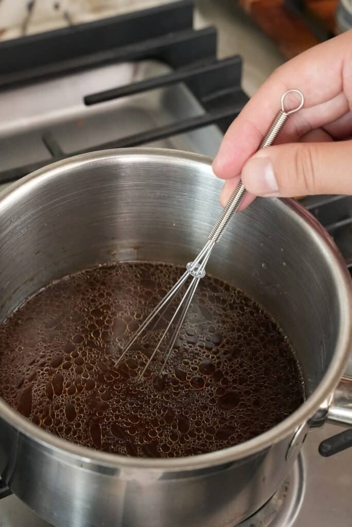 Mixing oyster sauce in a pot.