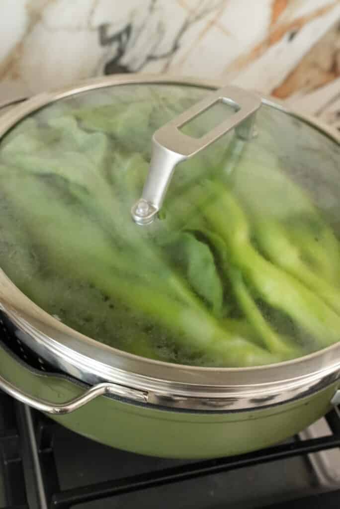 Steamed gai lan in a pan.