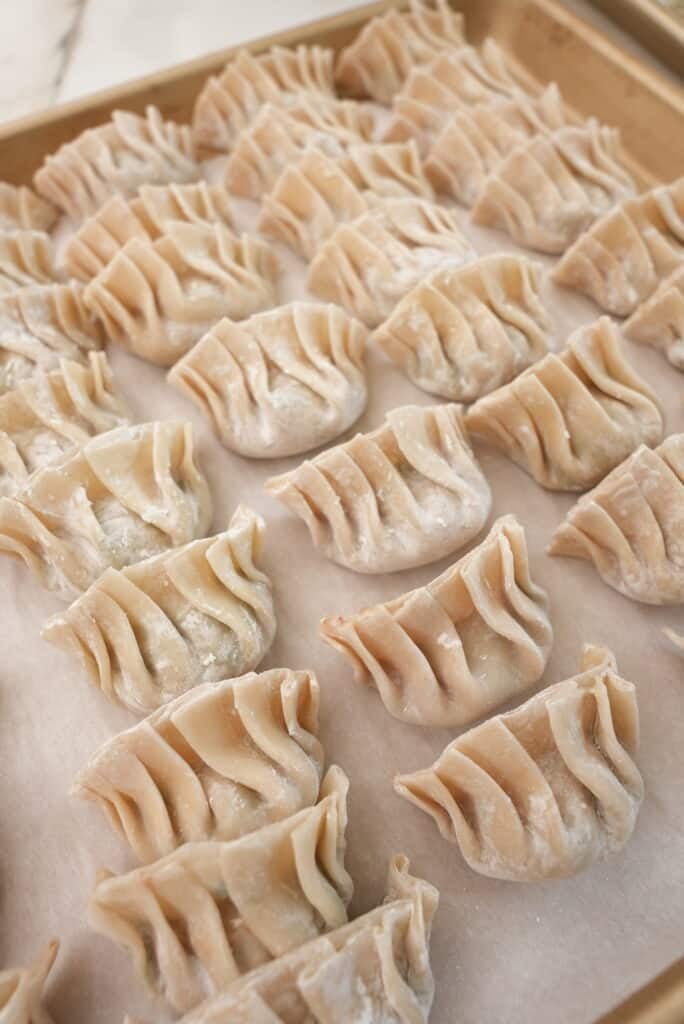 Folded dumplings on a tray