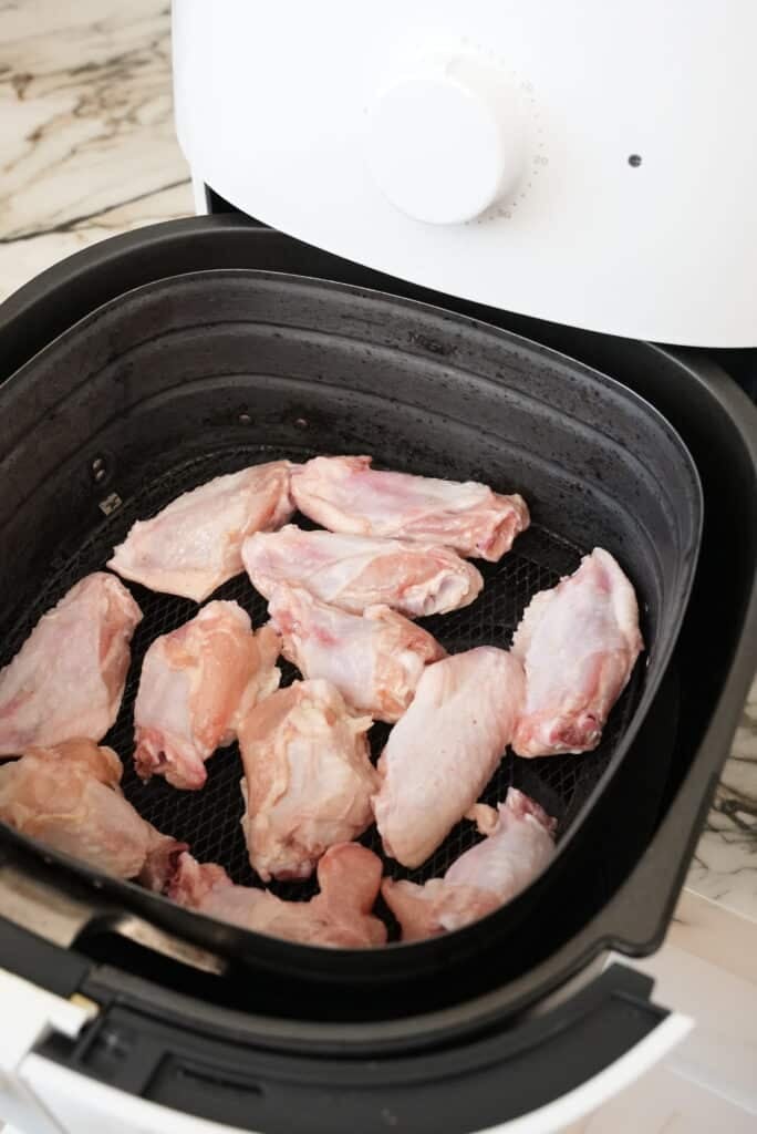 Air fryer chicken wings raw in the air fryer basket