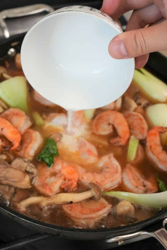 Adding cornstarch slurry into the sauce