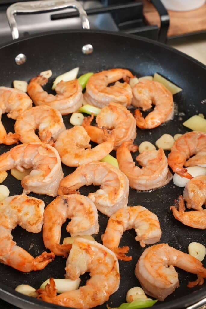Shrimp and garlic cooking in a pan