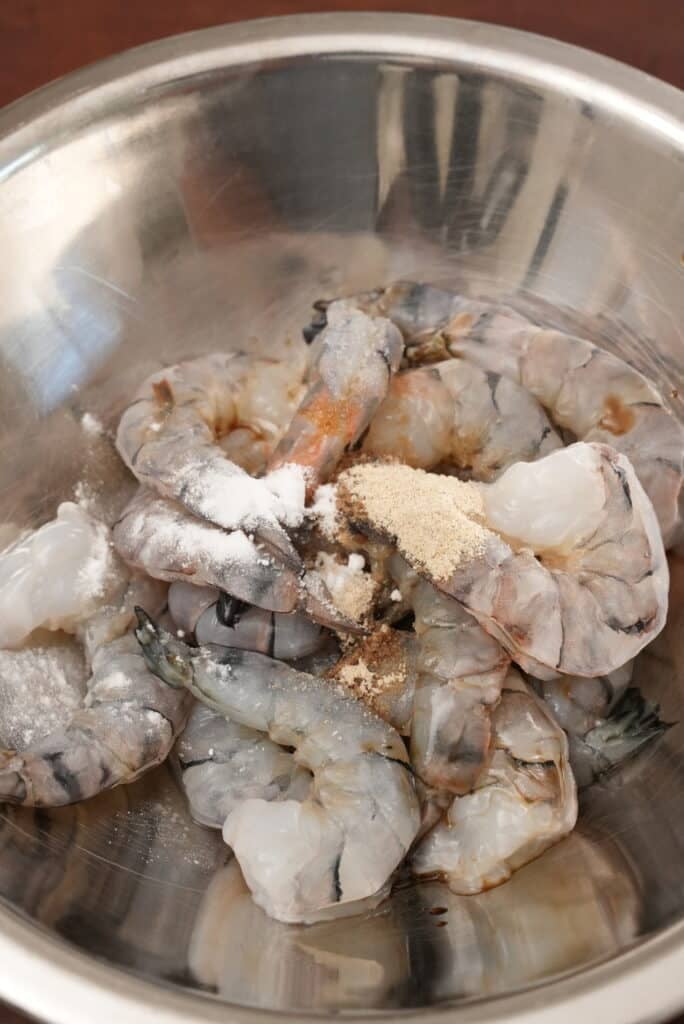 Shrimp marinating in a bowl