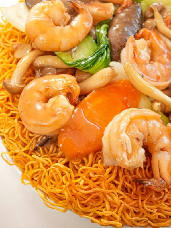 Hong Kong Shrimp Chow Mein on a plate with vegetables, shrimp, crispy noodles and gravy.