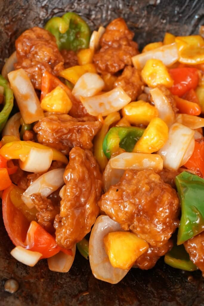 Sweet and sour chicken close up in a wok