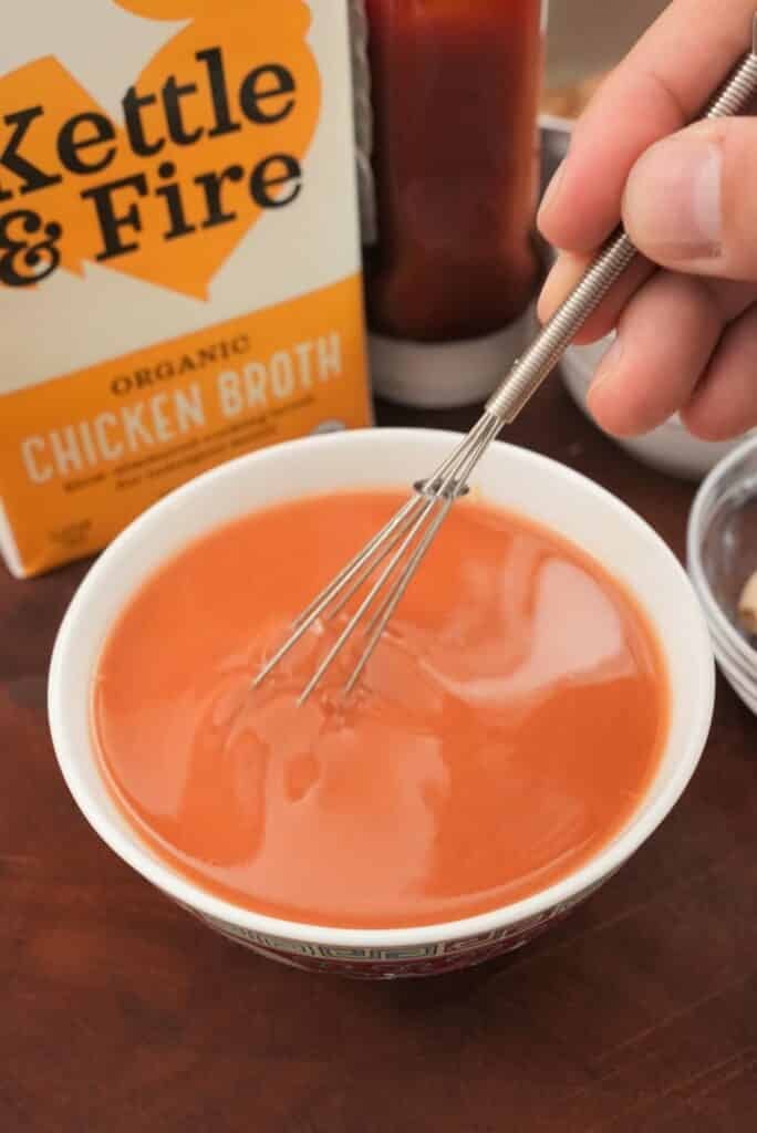 Mixing sweet and sour sauce in a bowl