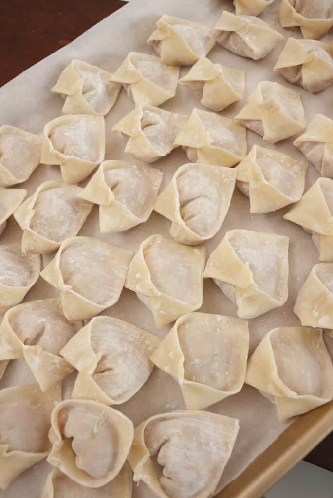 folded wontons on a tray