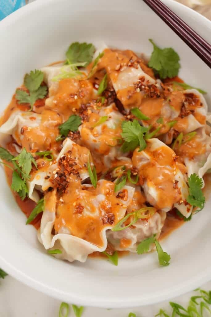 wontons with spicy peanut sauce close up