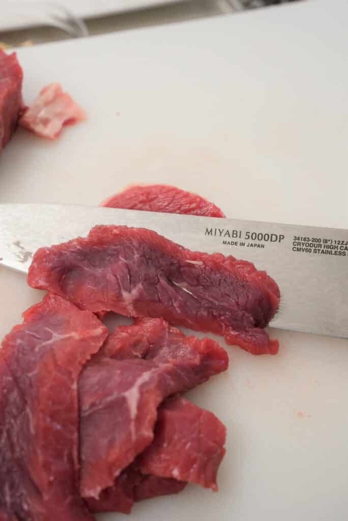 slicing steak into strips