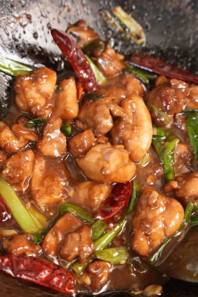 mongolian chicken cooked in a wok