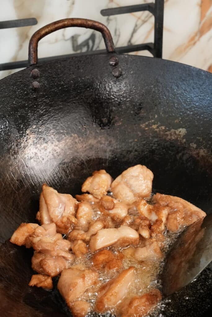 frying chicken in a wok